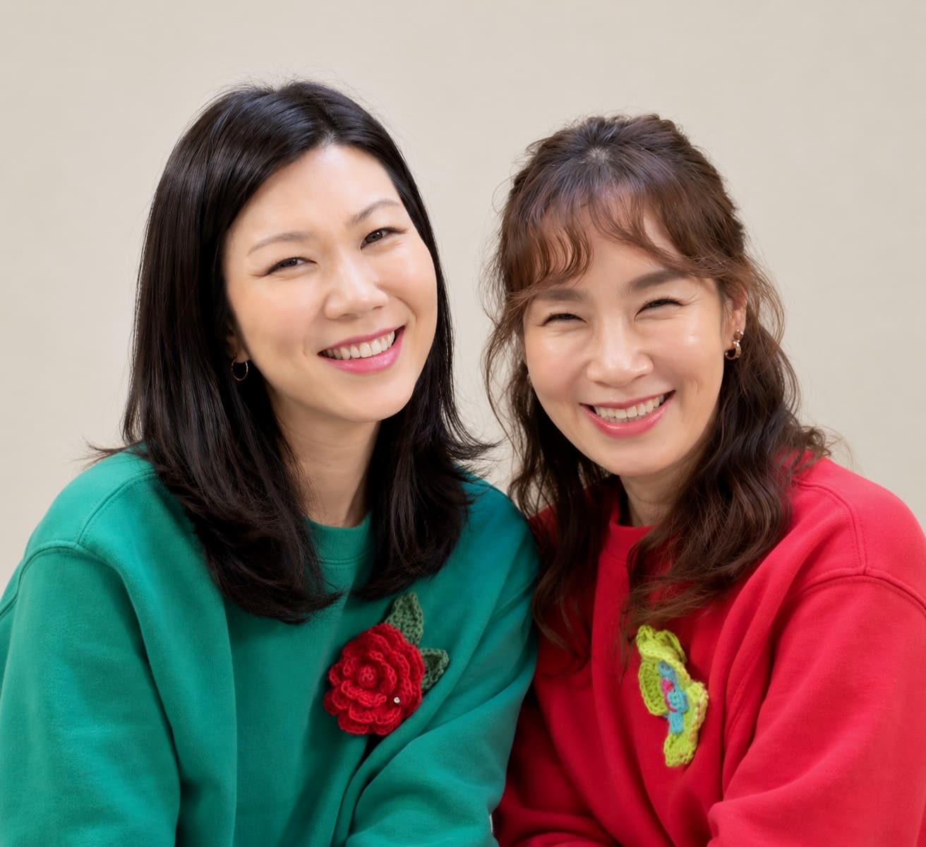 Esther Koh and Julie Kim, co-directors of PTL Treehouse, smiling side by side in a studio portrait