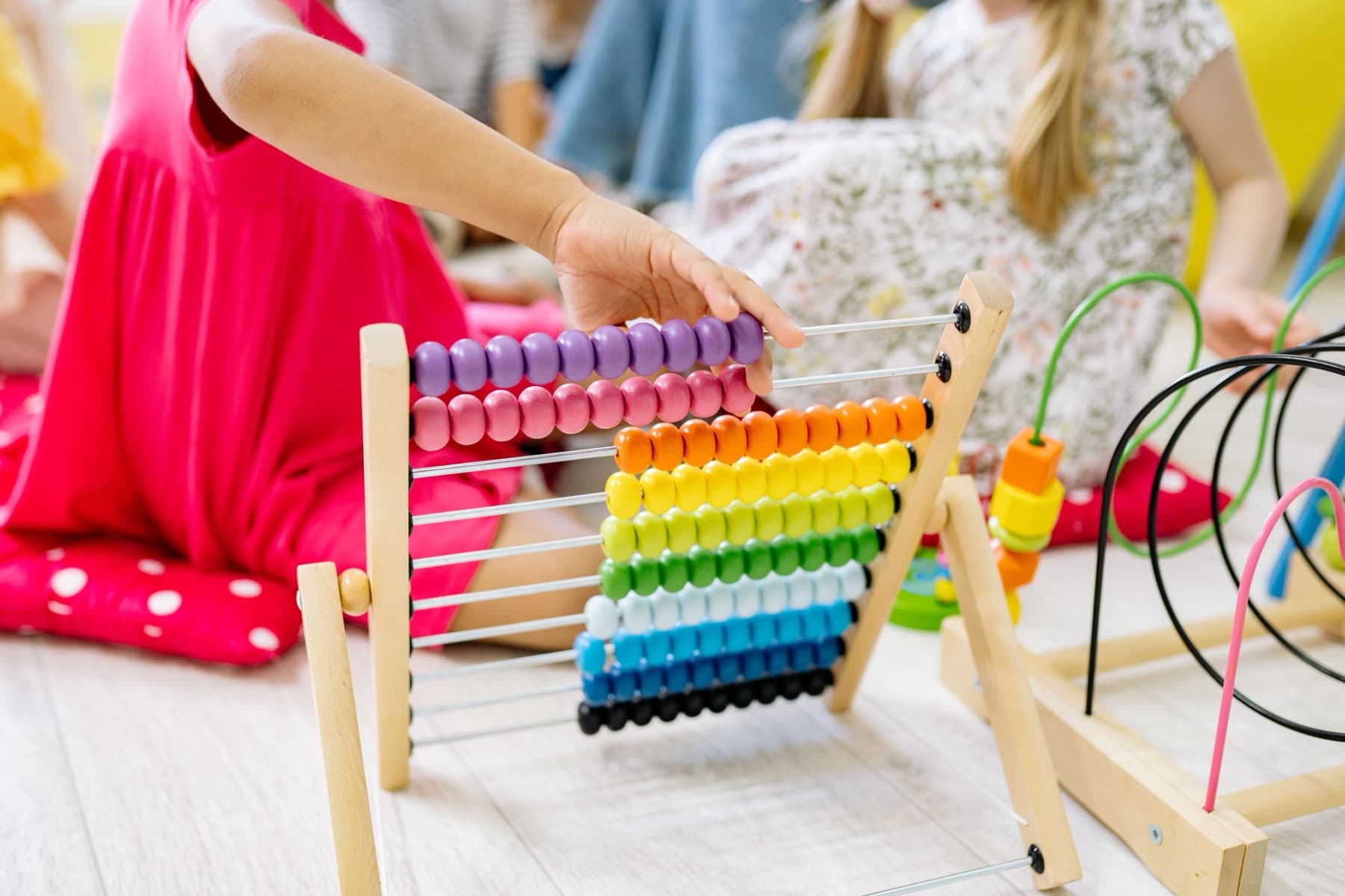 A child working with a colorful counting abacus